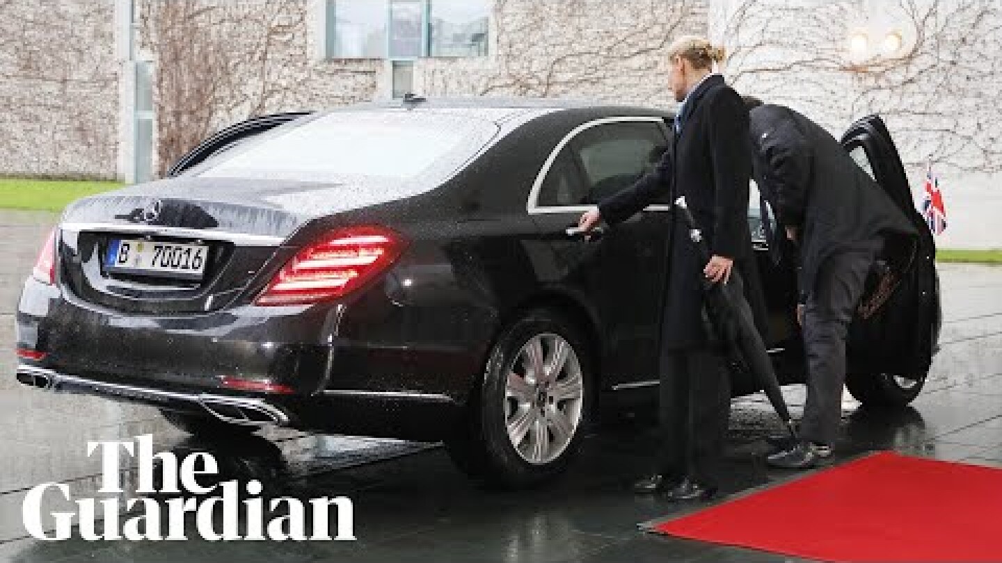 Theresa May gets locked inside her car as she arrives to meet Angela Merkel
