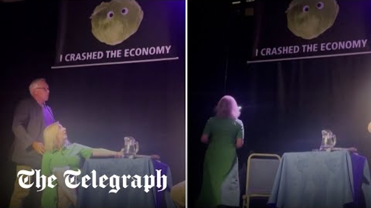 Liz Truss storms off stage after lettuce banner stunt